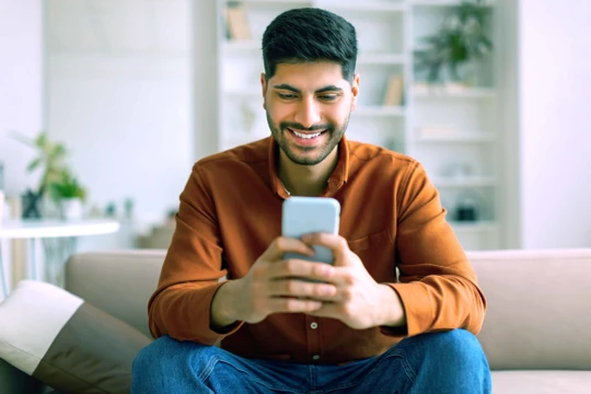 Zenus Bank Man Smiling At Phone