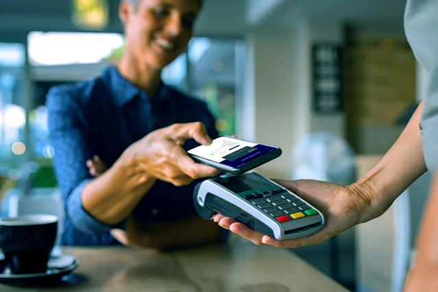 Zenus Bank Person Paying With Phone In Person